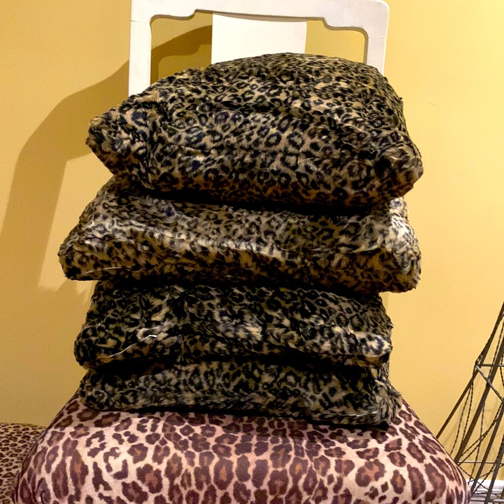 4 Custom made Cheetah print faux fur pillows. Measures 16” x 16” on all.